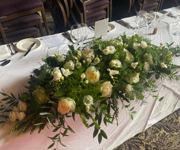 Wedding table flowers and venue arrangements by Flowers By Rosie