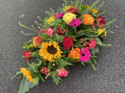 Florist choice spray - Lots of vibrant colours in this 2.5ft tribute. A mix of sunflowers , gerbera, carnations and roses with berries and assorted foliage