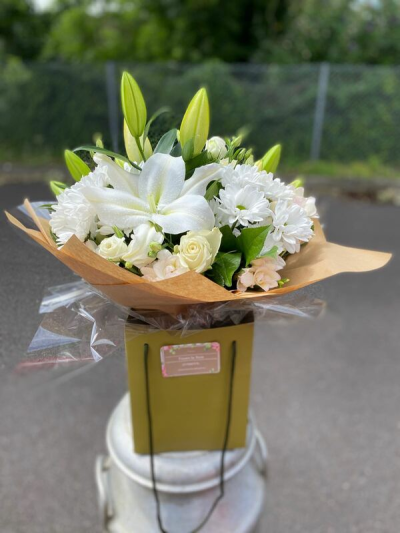 Classic Charm - A fresh and elegant white bouquet, beautifully arranged with lush greenery and presented in stylish natural wrapping.