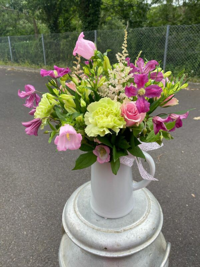 Rosy Rhubarb - A charming jug arrangement combining lively pinks and rich berry tones with fresh lime greens and delicate textural accents.